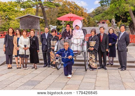 KAMAKURA JAPAN - APRIL 14 2014: Japanese wedding ceremony at Tsurugaoka Hachimangu shrine on April 14 2014 in Kamakura Japan. One the most important Shinto shrine in Kamakura