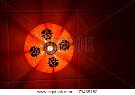 Red Chinese lantern under the ceiling. Traditional attribute