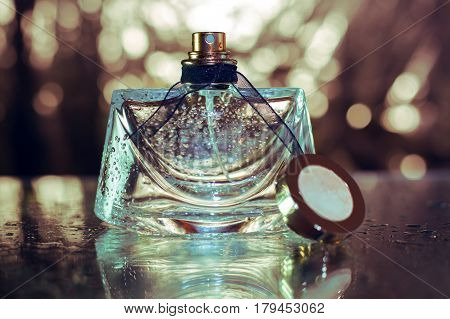 bottle of female perfume in gold background