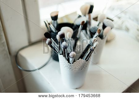 Brushes for make-up stand in the white cup