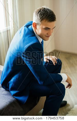 A man in a suit is sitting on the sofa. Man portrait. Businessman