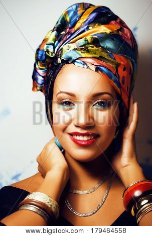 beauty bright real african woman with creative make up, shawl on head like cubian closeup smiling