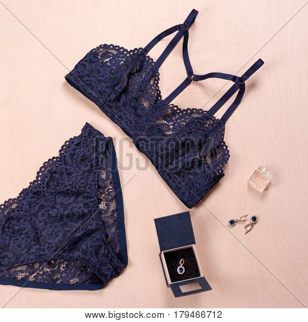 Shopping and fashion concept. Set of glamorous stylish sexy lace lingerie with jewelry, woman accessories on wooden background. Top view point, flat lay.