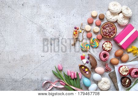Assorted easter sweets bakery cupcakes chocolate eggs and confectionery with space