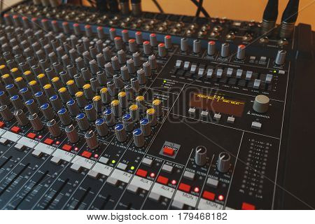 Music equipment closeup. Management console sound design at the event. Big black mixer with control knobs.