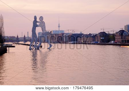 View on the Molecule Man sculpture on sunrise on the river Sprea. Berlin Germany - 01.04.2017.