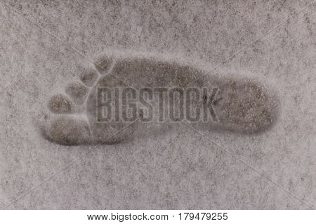 Barefoot right footprint of adult male on fluffy white snow.