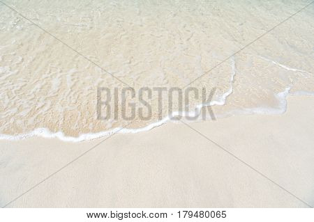Beautiful marine view on ?aribbean sea coast line with clean wavy surf ocean water on sandy beach in st. john Antigua at sunny day as natural background
