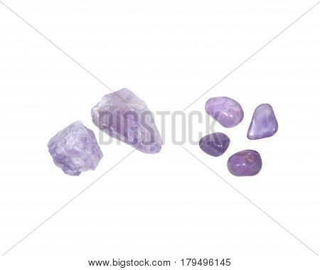 Amethyst: natural chunks from Madagascar and tumbled stones from Brazil isolated on white background