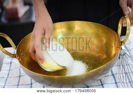 Bun Ingredient Putting Sugar Into A Brass Pan