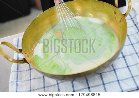 Putting The Ingredint Into A Brass Pan For Cooking A Bakery