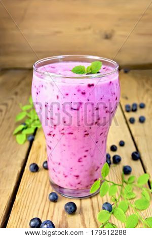 Milkshake With Blueberries In Glass On Wooden Table