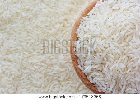 grains of Thai jasmine rice in wooden bowl on white rice background top view with copy space high resolution product.