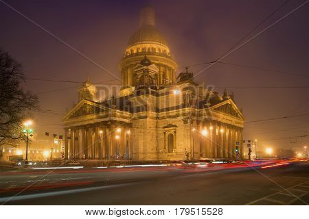 SAINT PETERSBURG, RUSSIA - MARCH 12, 2017: St. Isaac's Cathedral in the urban landscape of the misty night. March in Saint Petersburg