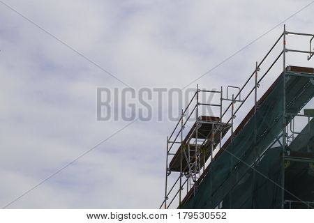 Construction scaffolding element. Blue sky background. Construction or reconstruction concept