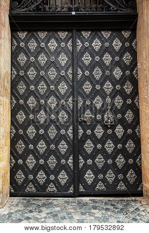 Ancient wooden gates and doors bound with metal .