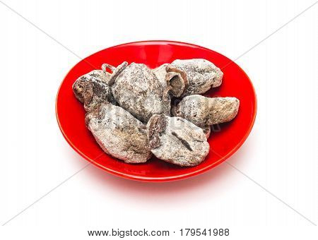 Dried persimmon fruits in red ceramic vase. Oriental sweets