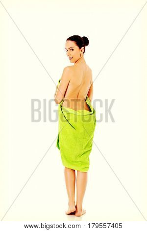 Young beautiful woman after bath full portrait isolated over white.