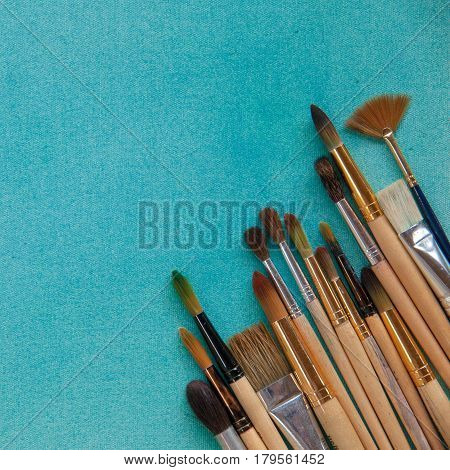 Lots Of Paintbrushes On Colorful Canvas Background