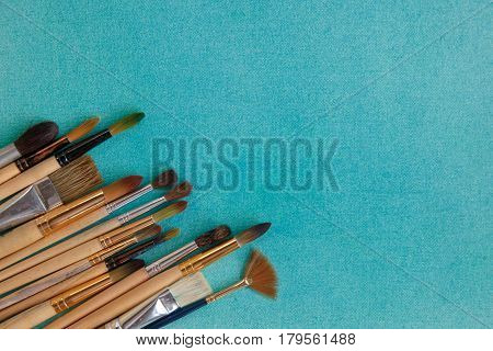 Lots Of Paintbrushes On Colorful Canvas Background