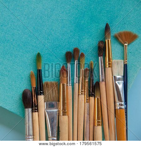 Lots Of Paintbrushes On Colorful Canvas Background
