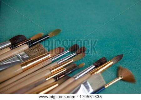 Lots Of Paintbrushes On Colorful Canvas Background