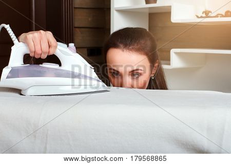 Young housewife work with steam iron