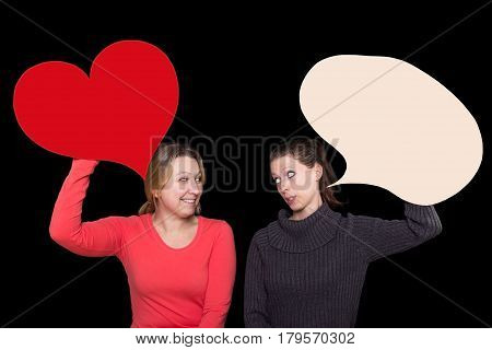 Two women holding a heart and a speech bubble up and talking