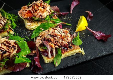 Smoked salmon flakes on salad bed and irish potato slims snacks, appetizers.