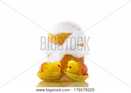 Two yellow kissing chicks and Easter cake with white ribbon isolated on white background