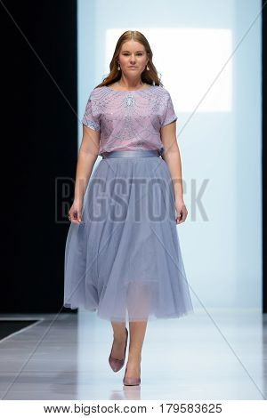 MOSCOW RUSSIA - MARCH 21 2017: Model walk runway for FABERLIC by VALENTIN YUDASHKIN catwalk at Autumn-Winter 2017-2018 Moscow Fashion Week. Plus-size fashion models.