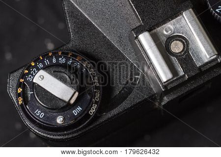 Old black film camera mode select wheel and hotshoe. Close-up macro photo of soviet retro SLR