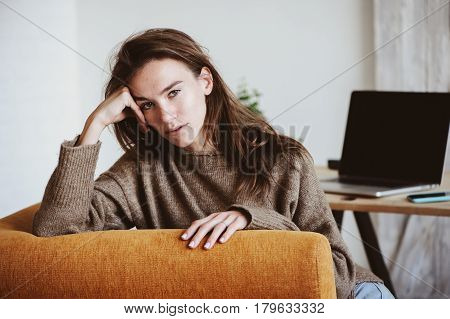 indoor portrait of beautiful feminine thoughtful young women alone in the room.