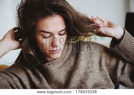 indoor portrait of beautiful feminine thoughtful young women alone in the room.