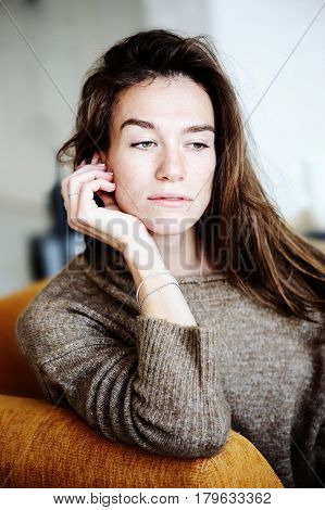 indoor portrait of beautiful feminine thoughtful young women alone in the room.
