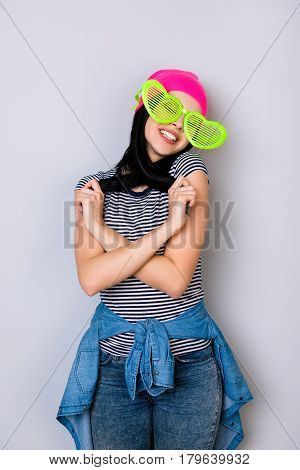 Young Stylish Smiling Woman Wearing Pink Hat And Big Funny Glasses Playing With Her Hair