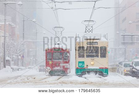 Toyama Japan - Jan 24 : Toyama Railway and Toyama city in snow day on JAN 24 2016 in Toyama Japan. Toyama Regional Railway is a transportation company in Toyama Toyama Japan. 