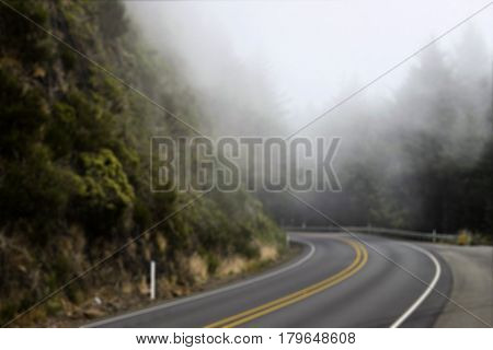 The bend in the road with fog in blurred for background