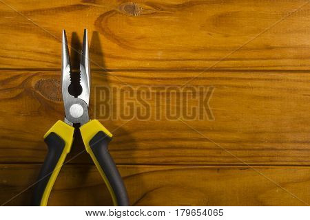 Close up of a multitool pliers on wooden background