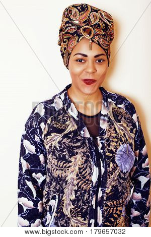 beauty bright african woman with creative make up, shawl on head like cubian closeup smiling, cheerful tan , lifestyle people concept close up