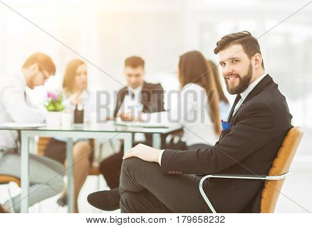 financial Manager of the company on the background of the working meeting the business team.the photo has a empty space for your text