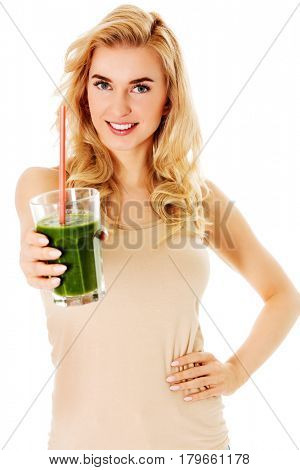 Young woman drinking green cocktail