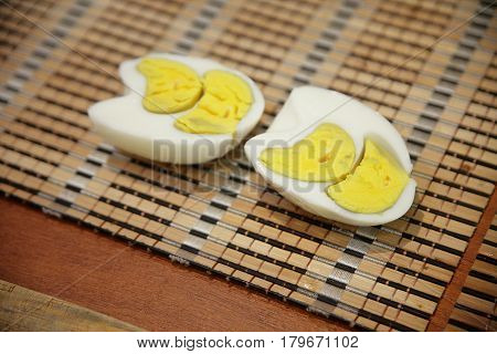 The boiled egg is irregular in shape. Two yolks inside. Cut in half. Organic Hard Boiled Eggs Ready to Eat.