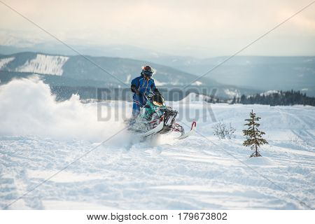 Rider on the snowmobile in the mountains ski resort in Amut Russia.