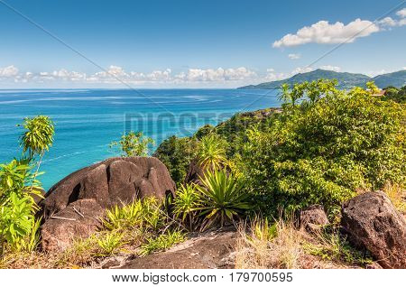 View from Anse Major Trail over the northwest coastline of Mahe island and granite rock in the foreground