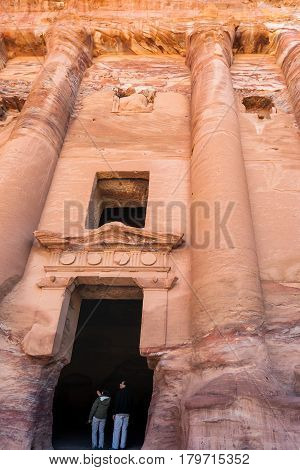 Tourists In Door Of Royal Urn Tomb In Petra Town
