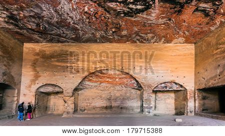 Tourists Inside Of Royal Urn Tomb In Petra Town
