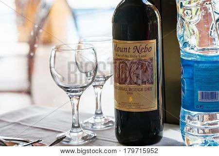 AQABA JORDAN - FEBRUARY 22 2012: Bottle of Jordanian wine Mount Nebo (Wine of the Holy Land) in restaurant. Local wine was produced there from ancient times as far back as Nabatean time