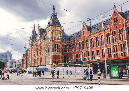Netherlands, June 2016, Amsterdam: Amsterdam Central train station. the oldest train station in Holland, view of the crowded station the beautiful Dutch and tourists visiting the city on a spring day.