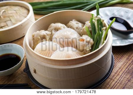 Traditional Chinese Dim Sum as close-up on Bamboo Steamer 